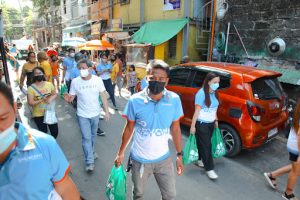 people carrying donation bag walking on streets