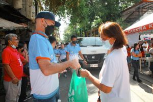 person handing a bag to a woman