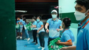 sourcefit employees passing donation bags to one another